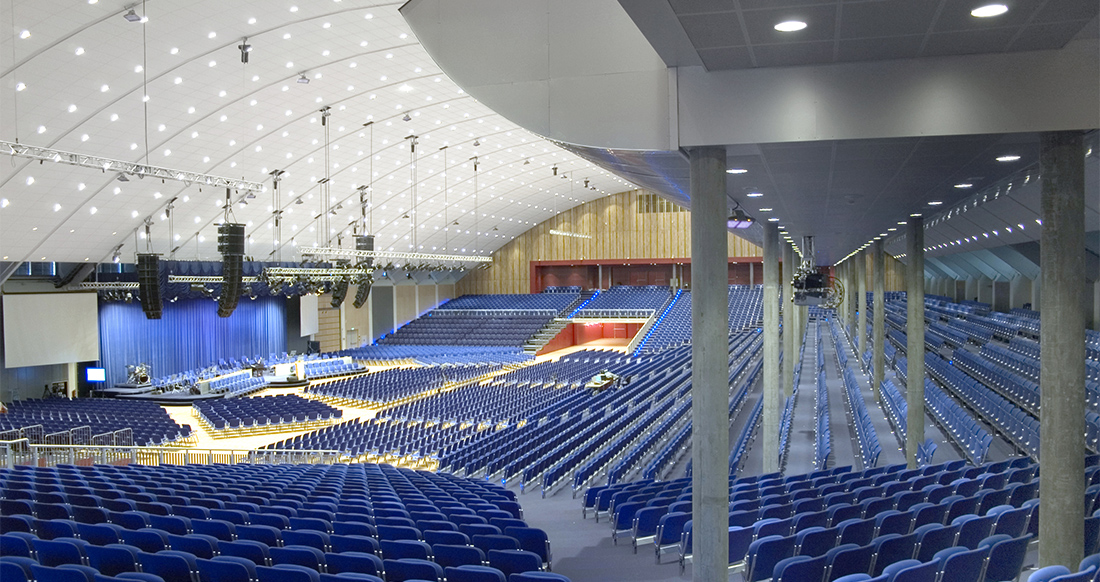 Audience seating and stage lighting inside the Oslofjord Convention Center