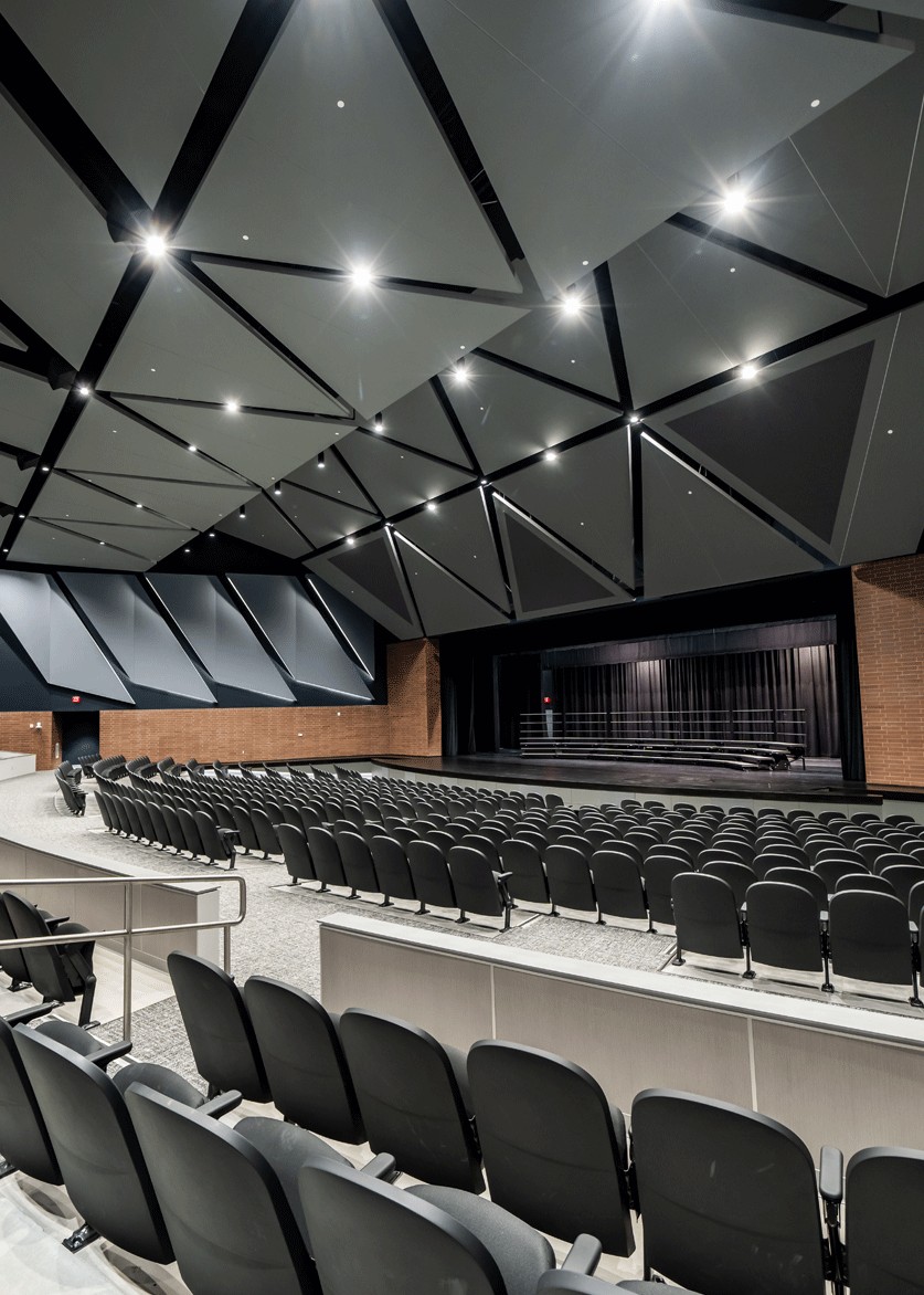 Vertical view of auditorium seating and ceiling cylinders at Maize Performing Arts