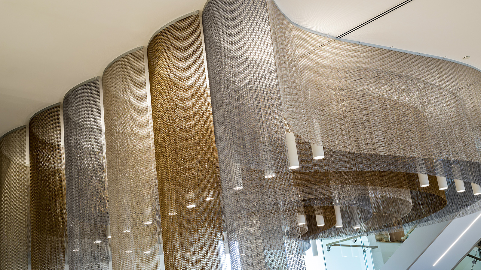 Duo 4 luminaire hidden behind woven ceiling mesh at BC Clark Jewelers