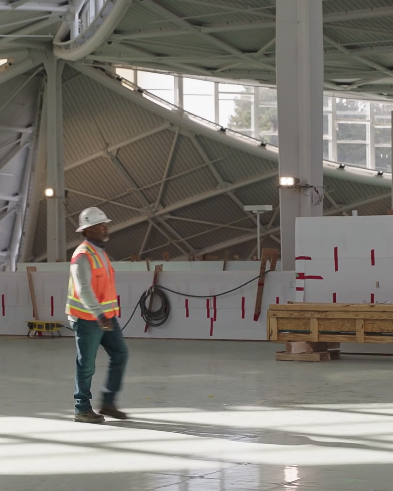 Construction worker walking pass in Google Bayview site