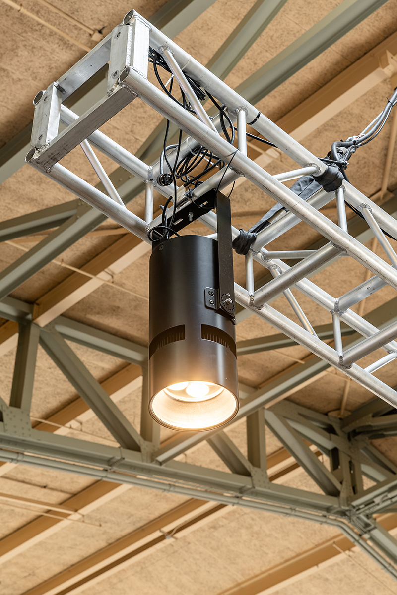 Atria 10 cylinder luminaire mounted to a movable truss inside Seattle Center Armory