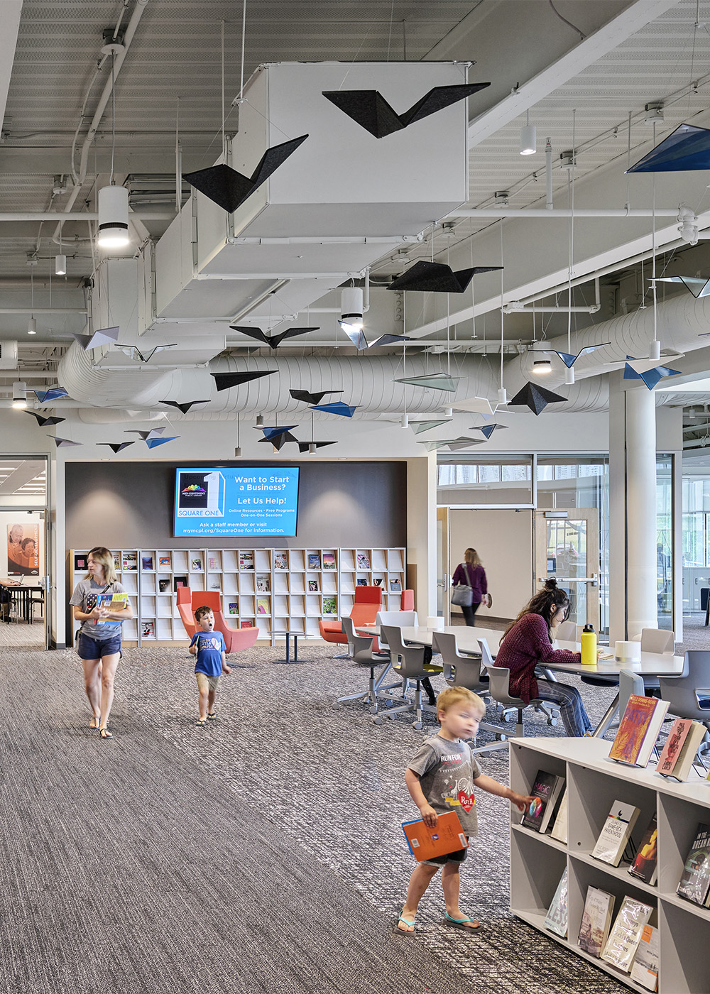 Interior library seating area illuminated by Vela cylinder lighting