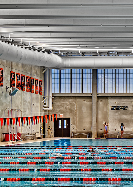 Competition pool at Kalamazoo College natatorium illuminated by perimeter-mounted Bolt floodlights